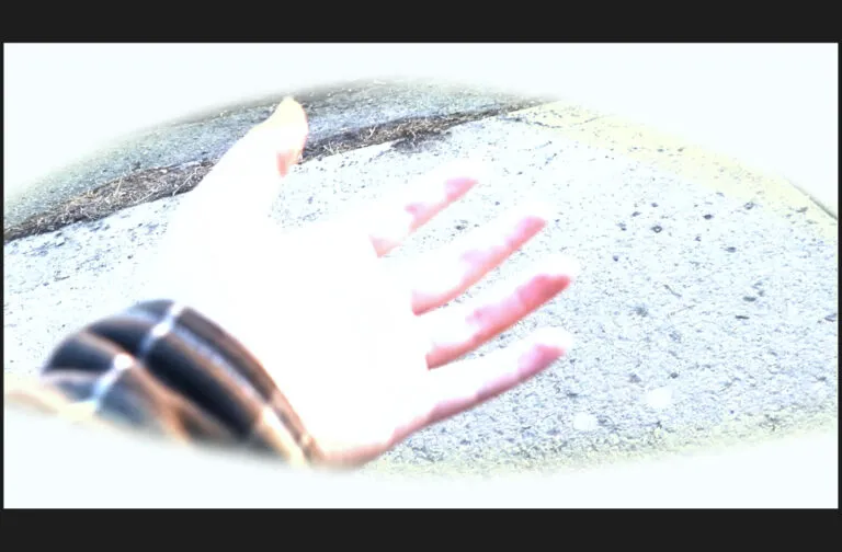 A brightly lit photo of look at a hand within an eye shape in white.